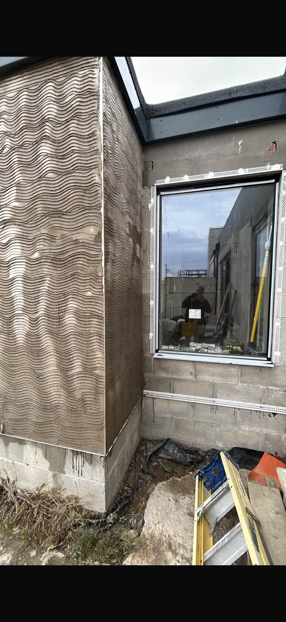 Close view of a newly fitted window and render preparation
