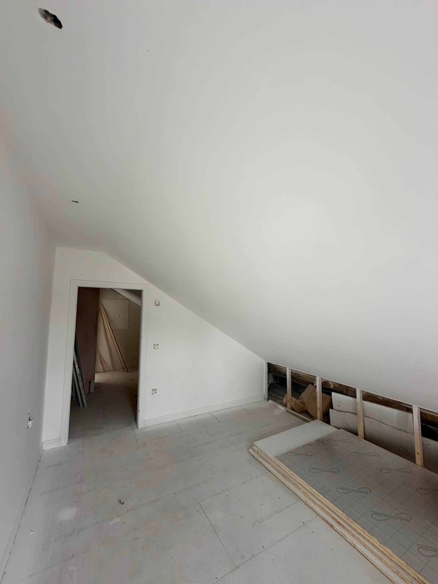 White-painted sloping ceiling and walls with joinery still in progress