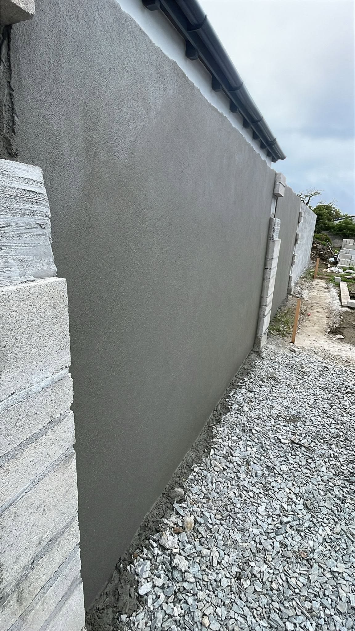 Front view of the rendered boundary wall and exposed block piers