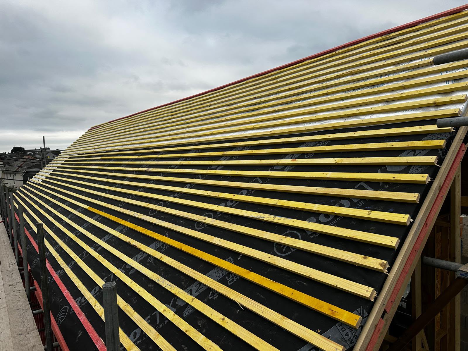 Roof membrane covered with horizontal timber battens before the roof covering is installed