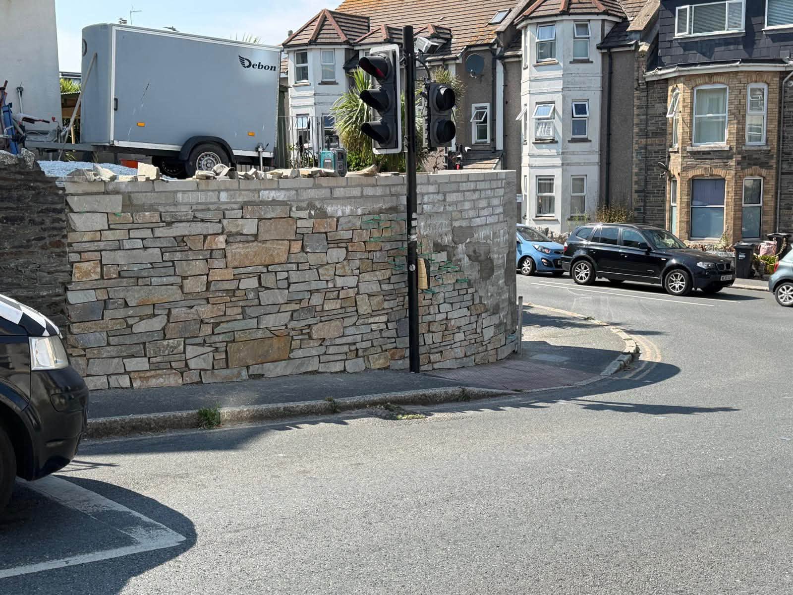 Progress photograph of stone cladding on the boundary wall