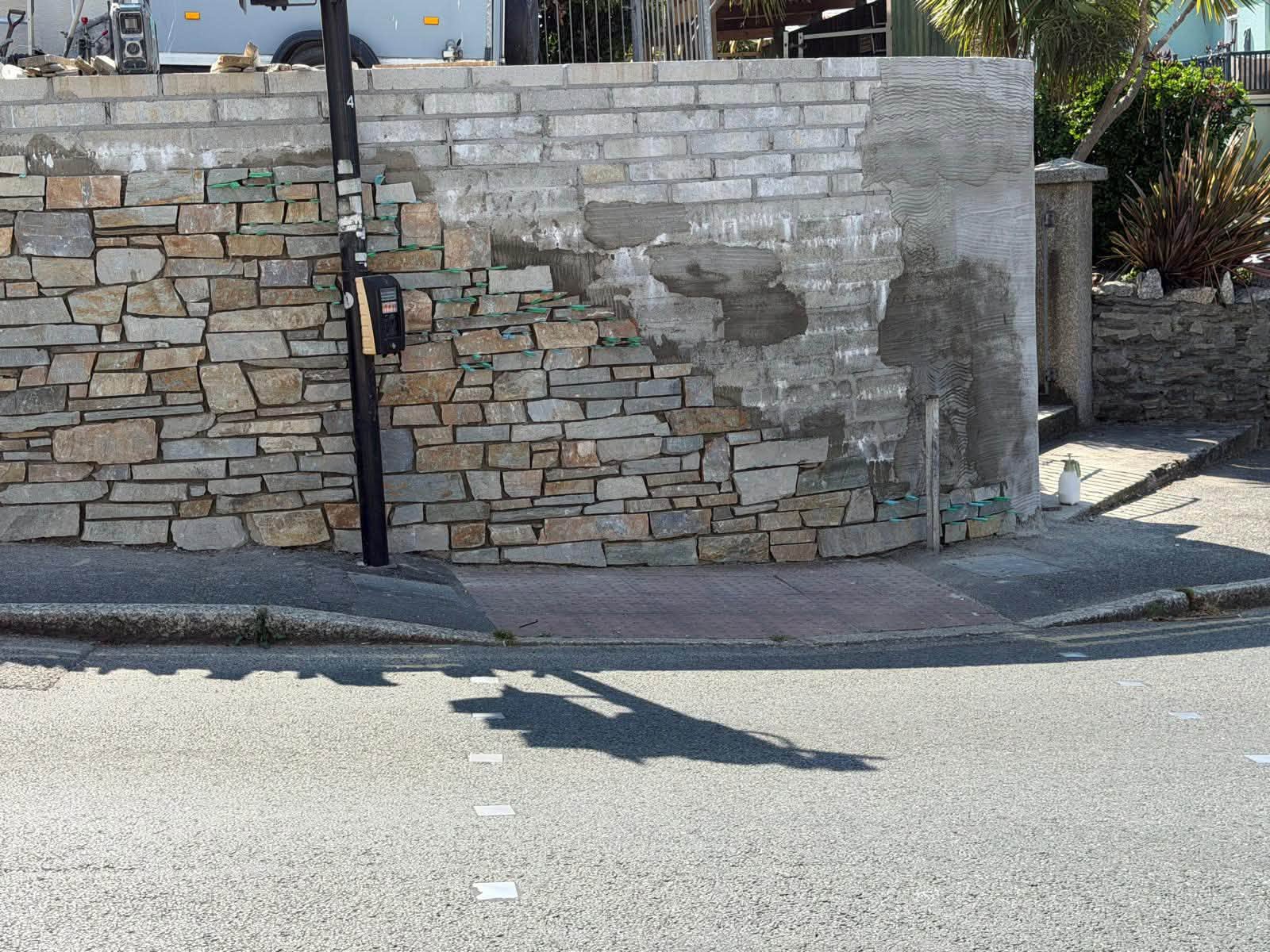 The same Newquay wall during stone cladding, with blockwork visible